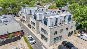 A multi-story building with a flat roof and large windows.