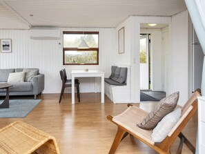 A room with a sofa, a dining table, a bench, and a chair. - 6 Person Holiday Home in Hemmet (Hemmet)