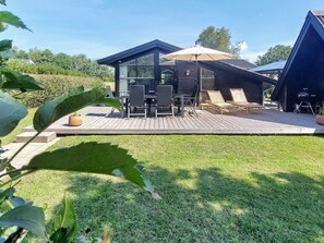 A modern house with a deck, outdoor furniture, and a barbecue area. - 6 Person Holiday Home in Hemmet (Hemmet)