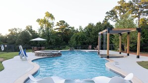 A swimming pool with a wooden deck, lounge chairs, and a pergola. - The  Willow  Cottage (TYLER)