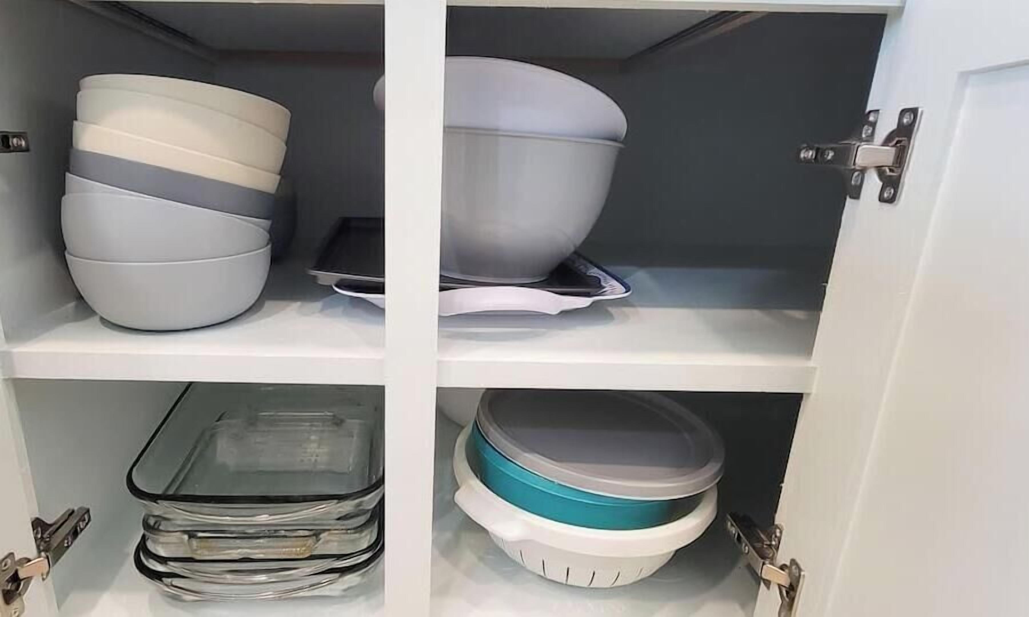A cabinet with shelves containing various kitchenware items.