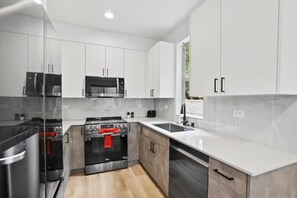 Fridge, stovetop, dishwasher, coffee/tea maker