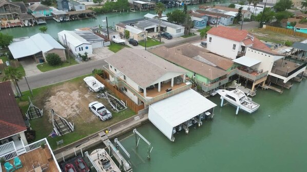 A residential area with houses, a dock, and a boat.