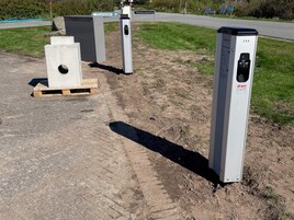 A parking area with concrete barriers and a sign indicating a parking space.
