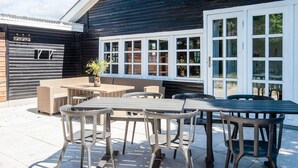 A patio area with outdoor seating and a large window.
