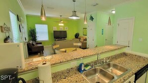 A kitchen with granite countertops, stainless steel appliances, and a two-basin sink. - In Entertainment District - Ample Bedding - Pool (South Padre Island)
