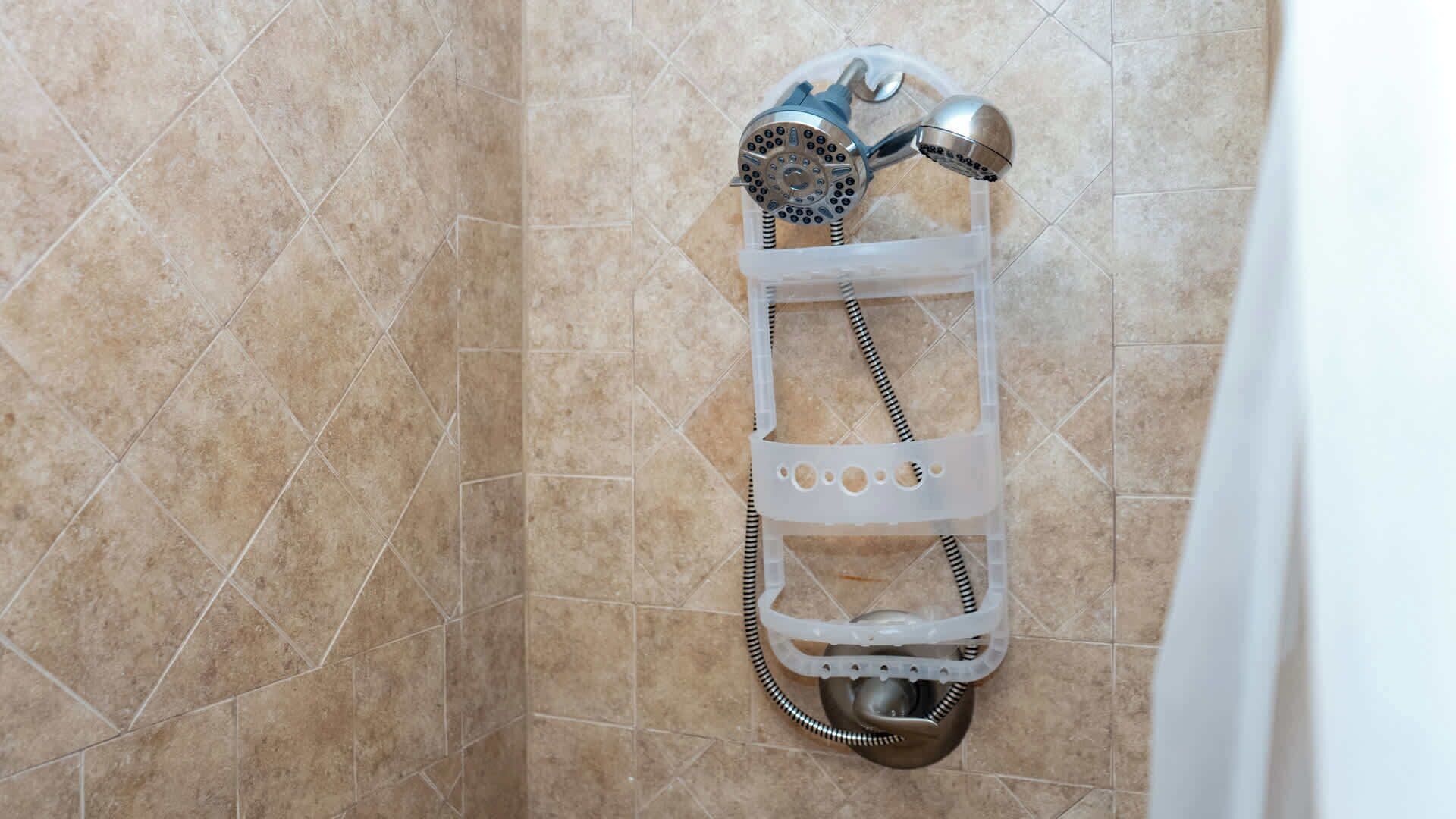 A shower with a handheld showerhead and a flexible hose.