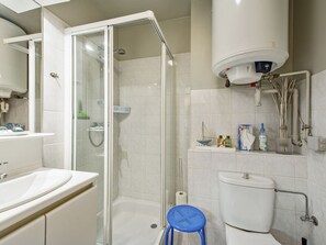 A modern bathroom with a glass-enclosed shower, a white toilet, and a sink with a mirror. - Studio in St-idesbald With Sea View Balcony (Koksijde)
