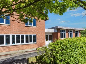 A brick building with large windows and a flat roof.