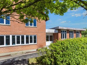 A brick building with multiple windows and a flat roof. - 12 Person Holiday Home in Roslev (Roslev)