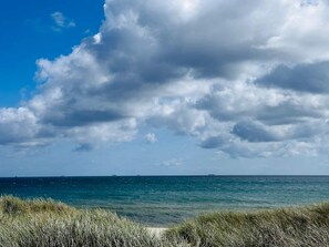 A beach with a clear sky and ocean. - 12 Person Holiday Home in Roslev (Roslev)