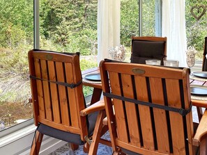 A wooden dining table with chairs, a glass, and a heart-shaped decoration. - 6 Person Holiday Home in Uddevalla (Uddevalla)