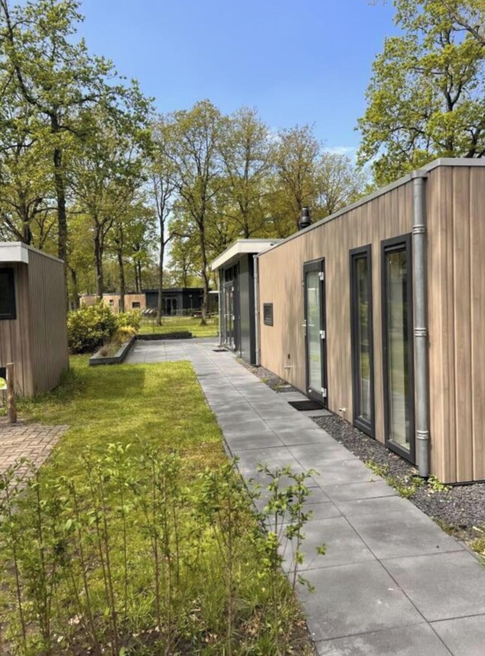 A modern building with a wooden exterior and large glass windows.