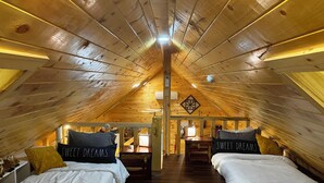 A cozy attic bedroom with two beds, wooden beams, and a sloped ceiling. - The LucKY Lodge: Hot Tub! New Build, 11 Miles to Natural Bridge (Campton)