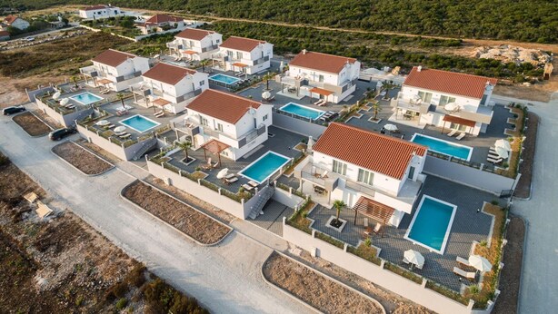 A modern resort with multiple white buildings, each with a swimming pool and outdoor seating areas. - Nicely Decorated Villa With Swimming Pool (Sukosan)
