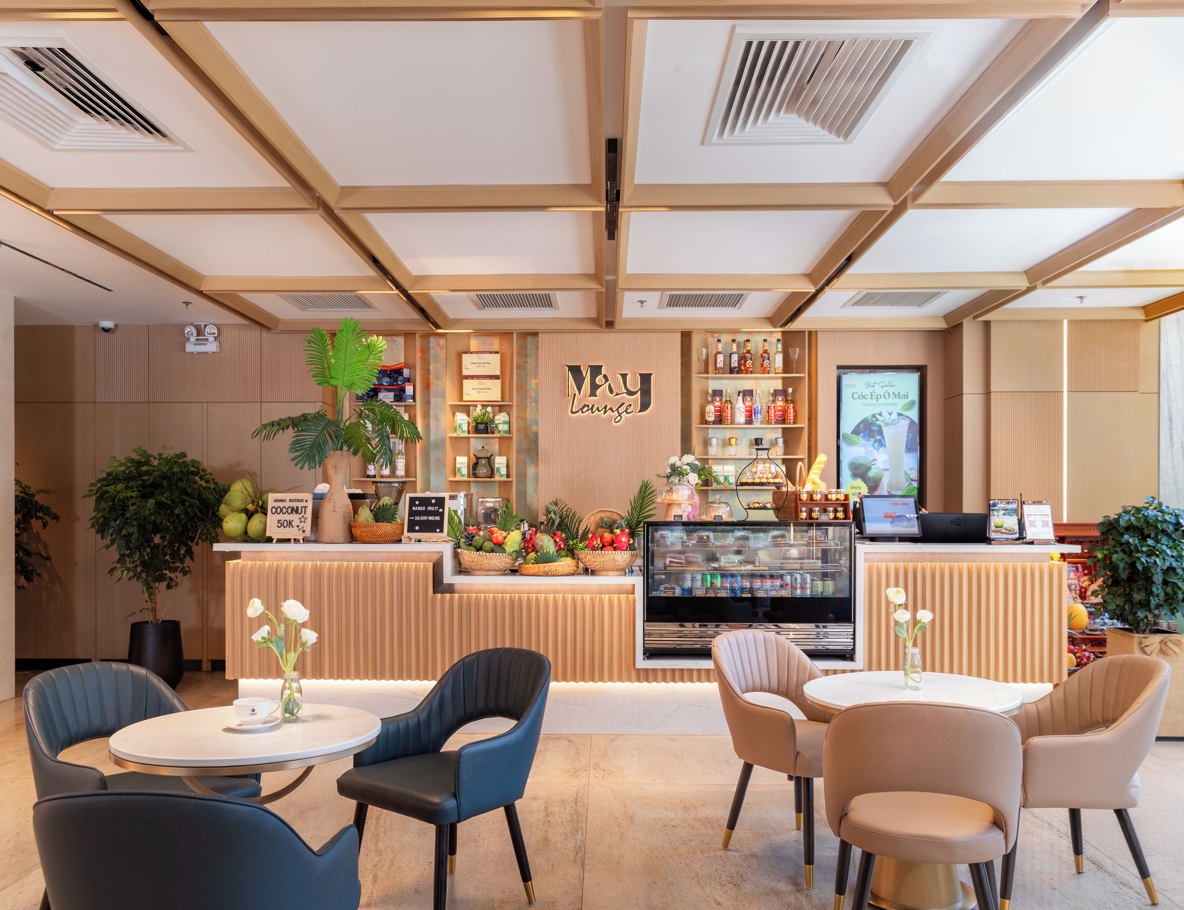 A modern bar area with a counter, seating, and a display of beverages.