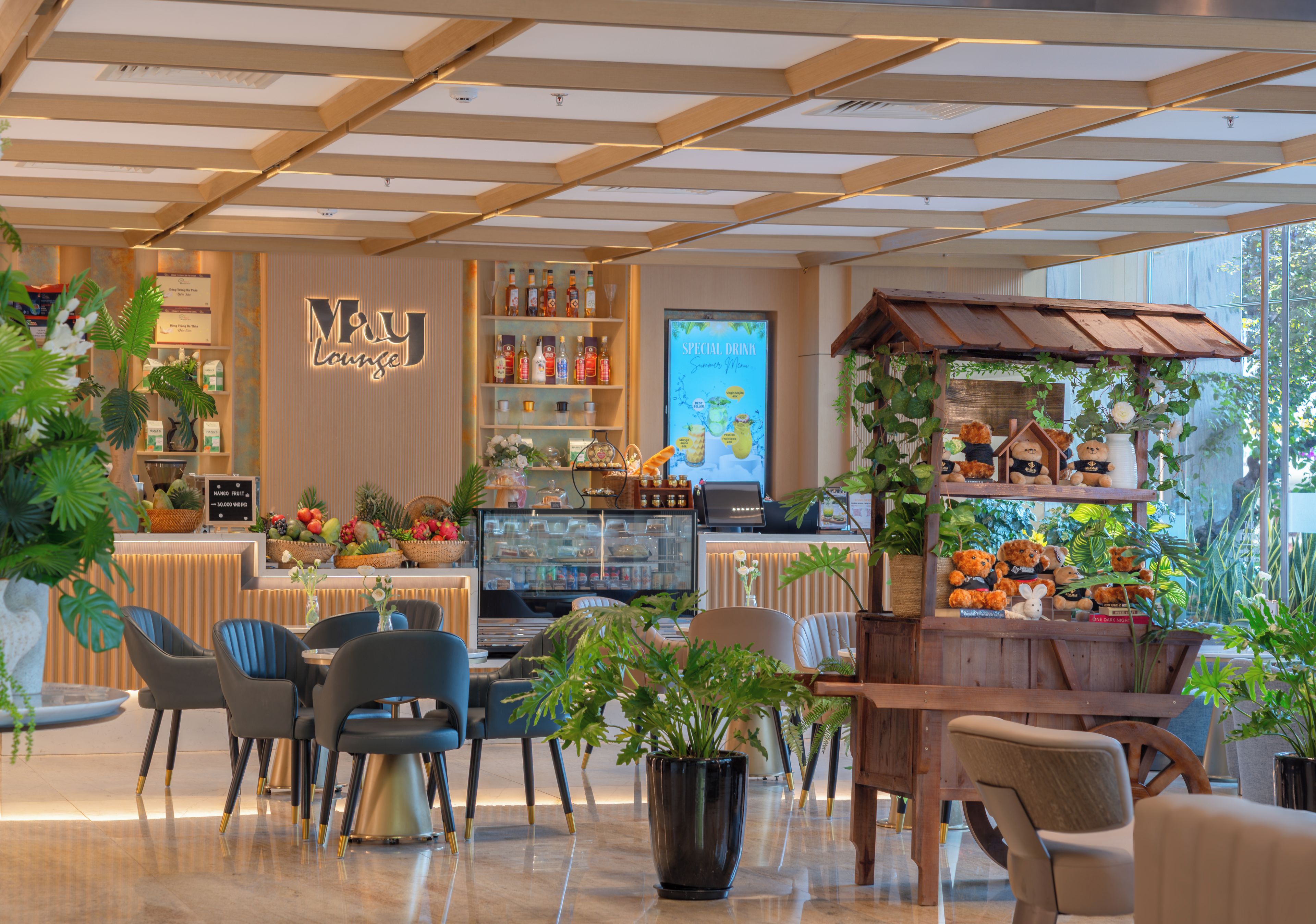 A modern lounge area with seating, a bar, and a display of beverages.