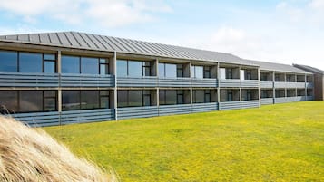 A modern building with a flat roof and multiple windows.