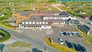 A large building with multiple parking spaces and a road leading to it. - 3 Person Holiday Park Home in Ulfborg (Ulfborg)