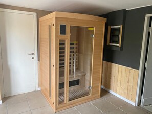 A sauna room with a wooden exterior, a door, and a window. - Chalet in Weris Near Durbuy Forests (Durbuy)