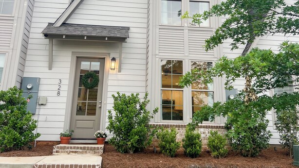 A two-story house with a front porch, a front door, and a small garden area with steps leading up to the door. - Back To College! 3 Bed Rooms 2.5 Bathroom- College Street near 280 (Auburn)
