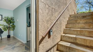 A staircase with a metal handrail leading to an upper floor. - Colorado Bay B (Colorado Springs)