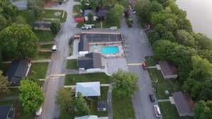 An aerial view of a residential area with houses, a swimming pool, and a road. - Cozy Cabin at Villager Resort on Lake Cumberland KY (Somerset)