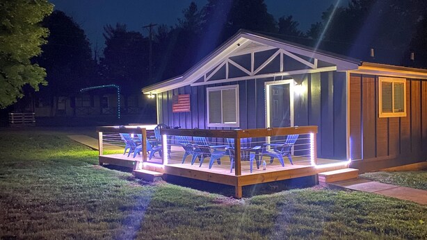 A small, single-story building with a porch and outdoor seating area. - Cozy Cabin at Villager Resort on Lake Cumberland KY (Somerset)