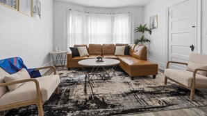 A living room with a sectional sofa, two armchairs, a coffee table, and a ceiling fan. - Entire apt near Olmstead Delaware park, North Buffalo, Zoo, UB & 2 Hosp. (Buffalo)