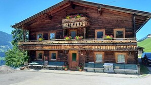 A wooden chalet with a balcony, multiple windows, and outdoor seating. - Spacious Holiday Home in Distelberg With Sauna (Aschau Im Zillertal)