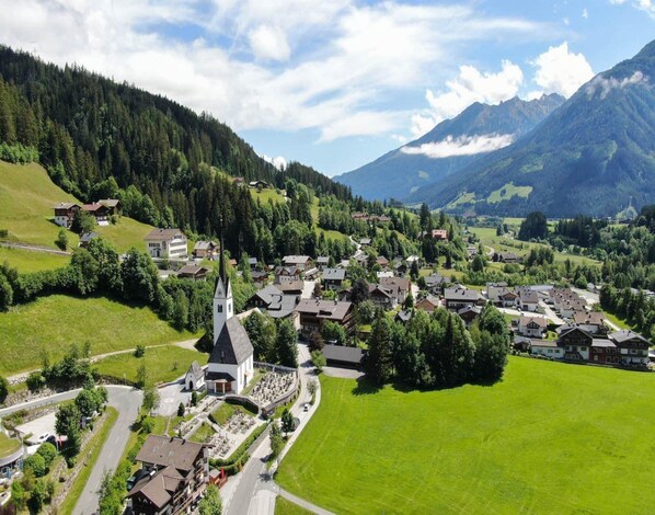 A village with a church, houses, and a cemetery.