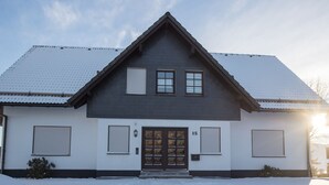 A two-story house with a dark roof, white walls, and a number 15 on the front door. - Small Studio in Neuastenberg With Balcony (Winterberg)