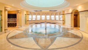 A spacious indoor pool with a circular design, surrounded by a tiled floor with a geometric pattern. - Best Resort in Cabo, Right on Medano Beach, Wonderful Staff, Gourmet Dining, spa (Cabo San Lucas)