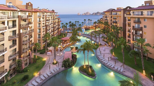 A resort with multiple buildings, a central pool area, and a view of the sea. - Best Resort in Cabo, Right on Medano Beach, Wonderful Staff, Gourmet Dining, spa (Cabo San Lucas)