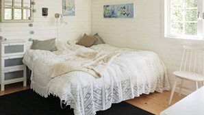 A bedroom with a bed, a nightstand, a dresser, and a window. - 4 Star Holiday Home in Norrtalje (Norrtälje)
