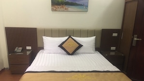 A hotel room with a bed, a nightstand, a telephone, and a painting on the wall. - Phuoc Thinh Hostel HN - by Bay Luxury (Hanoi)