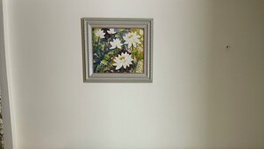 A hotel room with a large bed, a nightstand with a lamp, and a framed artwork on the wall. - Phuoc Thinh Hostel HN - by Bay Luxury (Hanoi)