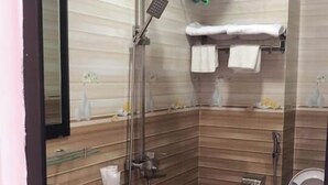 A modern bathroom with a shower, toilet, and sink. - Phuoc Thinh Hostel HN - by Bay Luxury (Hanoi)