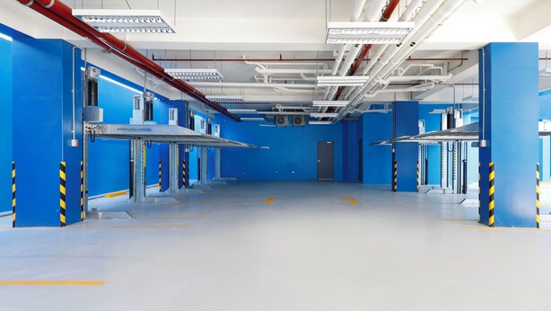 A clean, industrial-style room with blue walls and white floors, featuring multiple workstations and safety railings. - Hop Inn Hotel Iloilo (Iloilo)