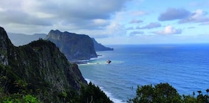 A coastal landscape with a prominent cliff and ocean view. - Holiday Home Casa Brisa Mar in Prazeres (Calheta)