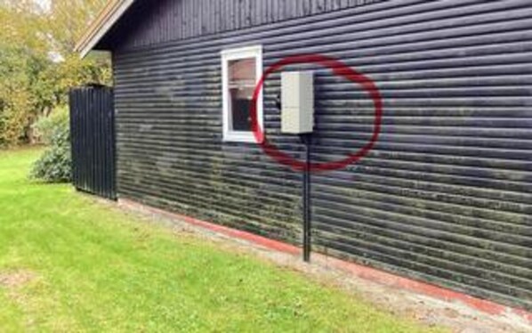 A building with a window and a utility box on the side. - 5 Person Holiday Home in Hals (Hals)