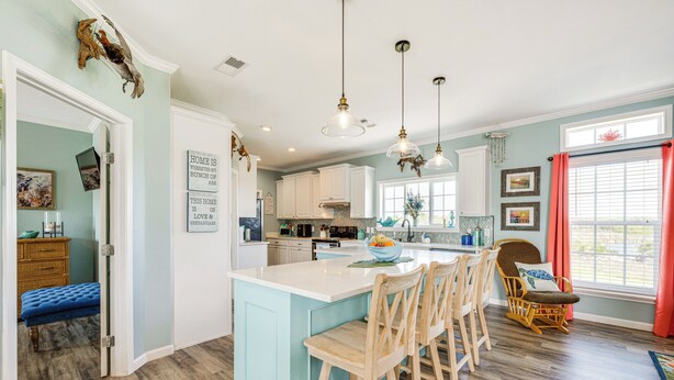 A spacious kitchen with a large island, wooden bar stools, and pendant lighting. - 1 Mi to Marina: Rockport Vacation Rental (Rockport)