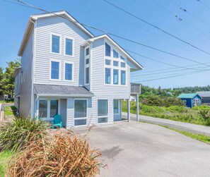 A two-story house with a front porch and a covered entryway. - #StayinMyDistrict Ocean Overlook (Port Orford)