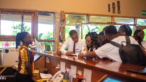 A reception desk with a computer monitor, phone, and various papers. - Sogakope Beach Resort & Spa (Sogakope)