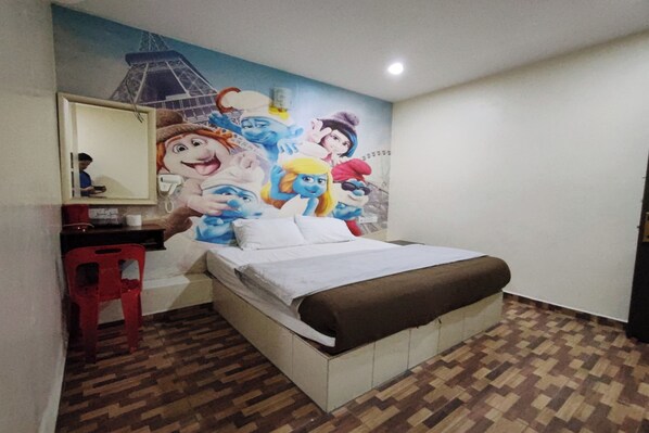 A bedroom with a bed, a red chair, a desk, and a wall mural. - Nova Hotel, Ipoh Tambun (Ipoh)