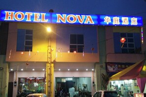A building with a sign that reads "HOTEL NOVA" and another sign in a different language. - Nova Hotel, Ipoh Tambun (Ipoh)
