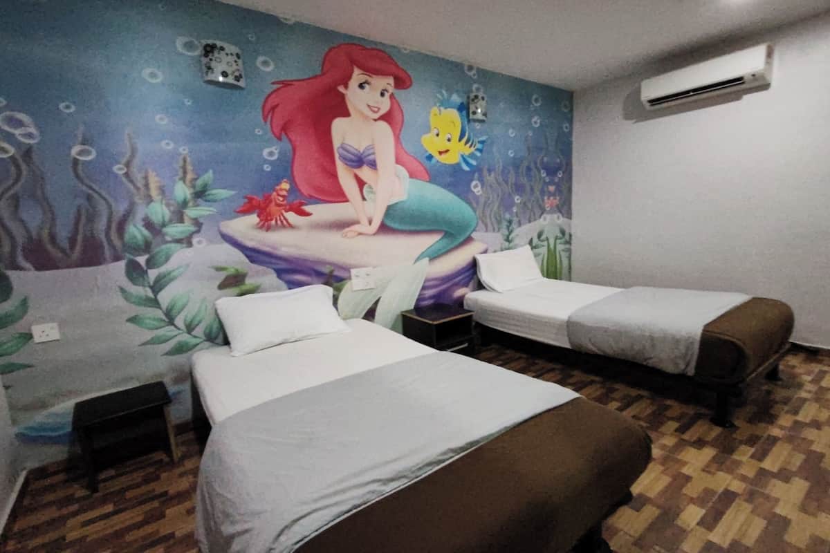 A room with two beds, a mural of a mermaid, and an air conditioning unit on the wall.
