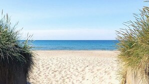 A sandy beach with a clear view of the ocean. - 6 Person Holiday Home in Skummeslovsstrand (Skummesloevsstrand)