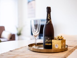 A bottle of Freixenet champagne, a glass, and a box of Ferrero Rocher chocolates on a tray. - Apartment by Belgian Sea and Dunes (Koksijde)