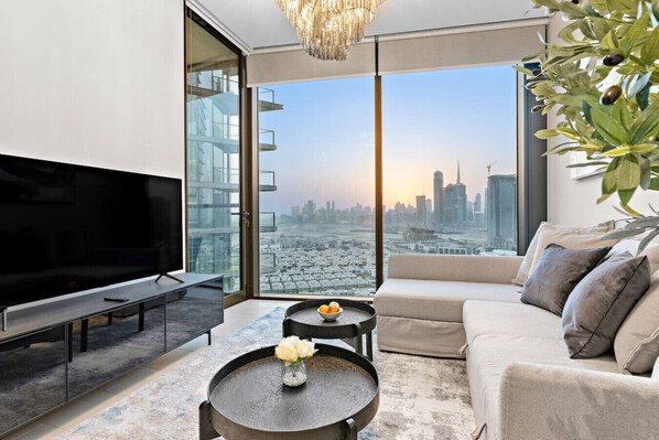 TV - Stylish 1BR Family Stay with Balcony, Gym, and Pool Access (Meydan)